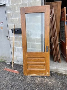 a wooden door sitting next to a brick building