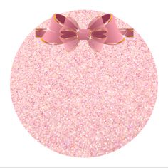 a pink bow on top of a round object with glitter in the bottom and gold trim