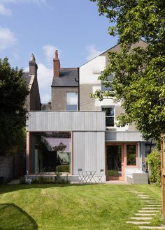 the house is made out of corrugated and has stairs leading up to it's front door