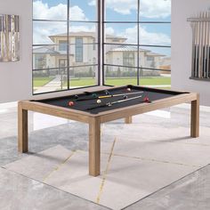 a pool table in front of a large window