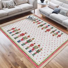 a living room with two couches and a christmas themed rug