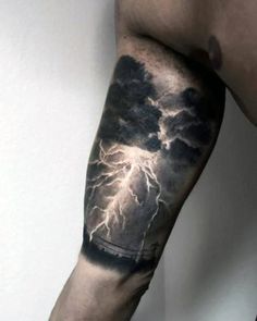 a man's arm with a storm coming out of the sky and lightning on it