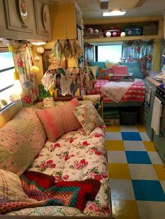 a living room filled with lots of furniture and decor on top of a checkered floor