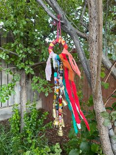 a bunch of colorful beads hanging from a tree