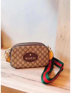 Brown GG Tiger crossbody bag with classic red and green shoulder strap, brand logo on the front and gold hardware accessories. Green and red webbing straps, oval Gucci leather label, (this item is packaged in a dust bag or box) Canvas Messenger Bag, Leather Label, Gucci Leather, Green And Red, Bag Bag, Travel Size, Gold Hardware, Brand Logo, Messenger Bag