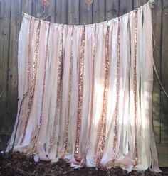 a pink and white curtain hanging on a fence