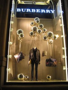 a burberry window display with lots of balloons