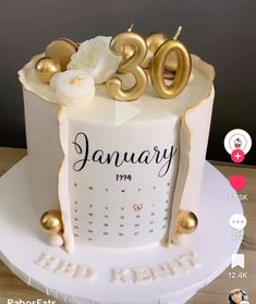 a white and gold birthday cake with the number twenty on it