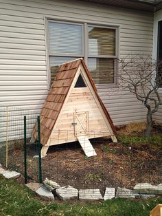 a small wooden house with a roof made out of wood