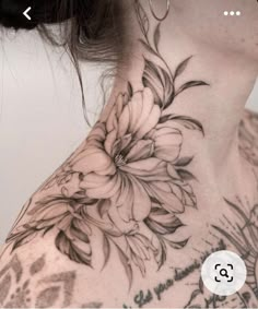 a woman's neck with flowers on it