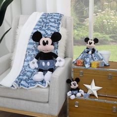 a mickey mouse stuffed animal sitting on top of a chair