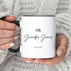 a woman holding a coffee mug with the name dr jenny jones on it in her hands