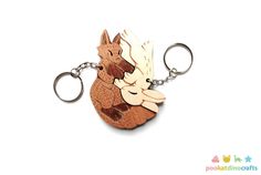 a wooden keychain with an image of a squirrel on it's back