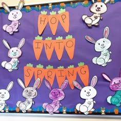 a bulletin board with rabbits and carrots on it that says hop into spring in front of purple background