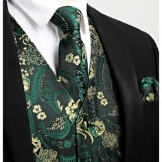 a man wearing a black suit with green and gold paisley print on the lapel