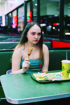 a woman sitting at a table eating food