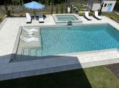 an aerial view of a swimming pool with lounge chairs