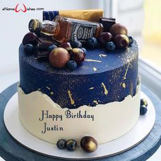 a birthday cake with liquor bottles and other items on it's top, sitting in front of a window