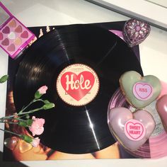 there is a vinyl record with the word hlce on it next to some heart shaped candies