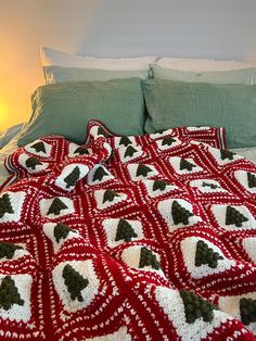 a crocheted christmas tree afghan on a bed