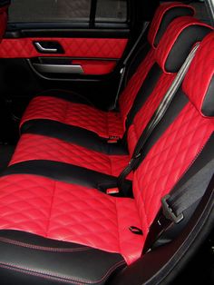 the interior of a car with red and black leather upholsters on it