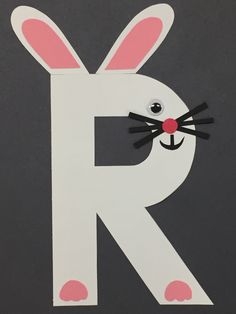 the letter r is made up of paper and has a bunny's face on it