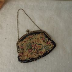 "Vintage Black Tapestry Purse / Black Handbag 1940's / Floral And Brass Clasp Evening Bag Beautiful black clutch with a floral garden design tapestry purse. The clasps is ornate gold metal with 1 black stone. Cream satin interior is in good condition with one pocket and mirror. In good vintage condition.   Measures approx:  6 \" x 4 1/2\" This is a vintage item , sold as is with its original charm and patina." Embroidered Handbag, Cute Handbags, Black Clutch, Floral Tapestry, Vintage Bags, Cute Bags, Black Handbags, Girls Accessories, Clutch Handbag