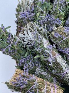 lavenders and sage are tied together in wicker baskets