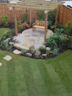 a wooden bench sitting on top of a lush green field next to a small garden