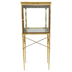 an antique brass and glass display cabinet