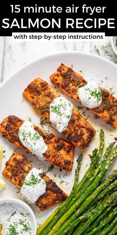 grilled salmon and asparagus on a white plate with ranch dressing in the middle