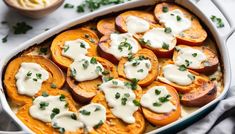 a casserole dish filled with sweet potatoes topped with sour cream and parsley