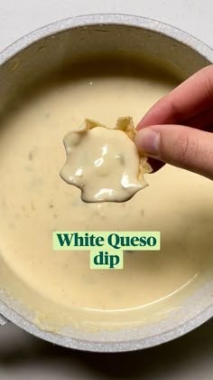 a person dipping some kind of sauce in a bowl