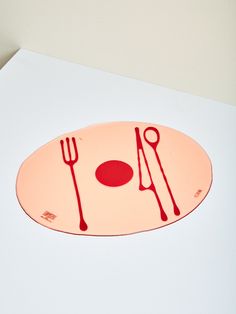 a plate with utensils and a fork on it sitting on top of a table