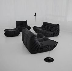 an unusual set of black leather sofas and chairs