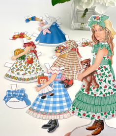 the paper dolls are all dressed up and ready to be made into children's clothing