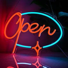 a neon sign with the word open on it