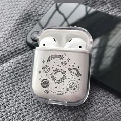 an airpods case with space and planets on it