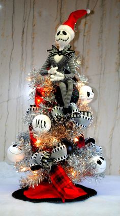 a christmas tree decorated with ornaments and lights in the shape of jack skellings