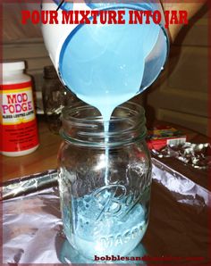 a person pouring water into a mason jar with the words pour mixture into vari