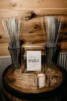 candles are sitting on top of a wooden table next to a sign that says let love sparkle