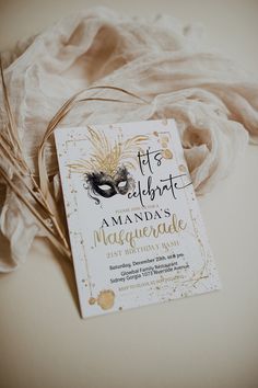 an elegant masquerade birthday party with mask and feathers