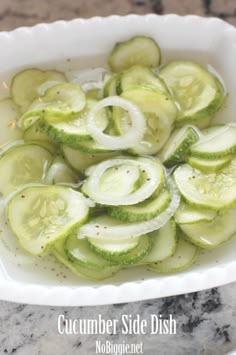 cucumber side dish in a white bowl on a marble countertop with the words cucumber side dish above it