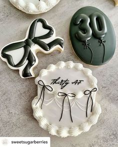 three decorated cookies sitting on top of a table