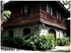 an old building with plants growing in front of it and the words traveler on top