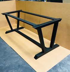 a black bike frame sitting on top of a table