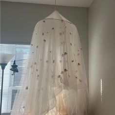 a white canopy hanging from the ceiling in a room