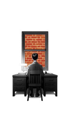 a person sitting at a desk in front of a brick wall and looking out the window