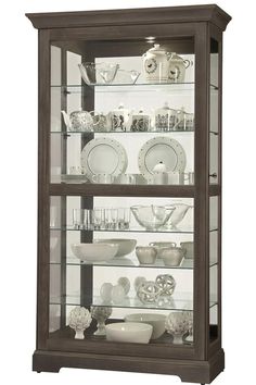 a display case filled with lots of glass and dishes on top of it's shelves