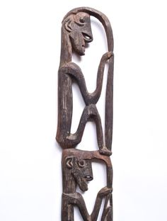 an old wooden sculpture is shown on a white background with the image of a woman holding a child